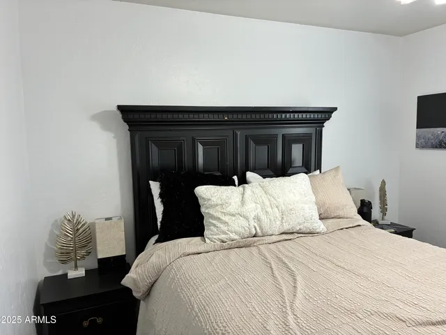 a bedroom with a bed and hallway