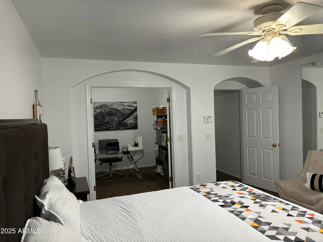 a bedroom with a bed and a chandelier