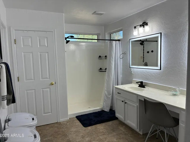a bathroom with double sink and two mirror