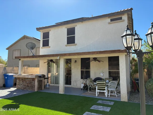 a view of a house with backyard and a tree
