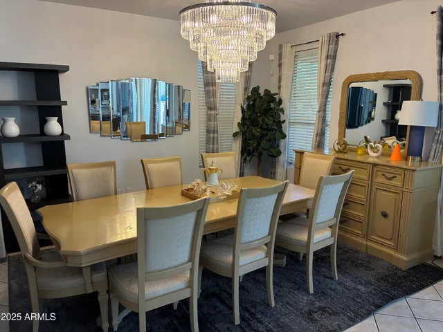 a view of a dining room with furniture and chandelier