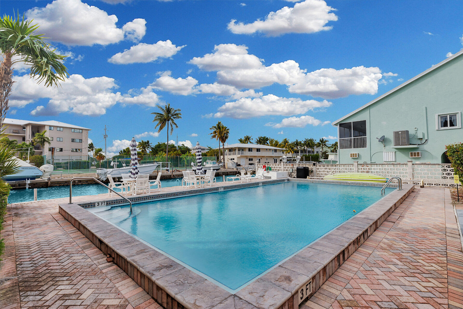 423 Sombrero Beach Road, Unit 9 Marathon, FL 33050 - Photo 30 of 42 Pool Deck with Canal & Boat Slips