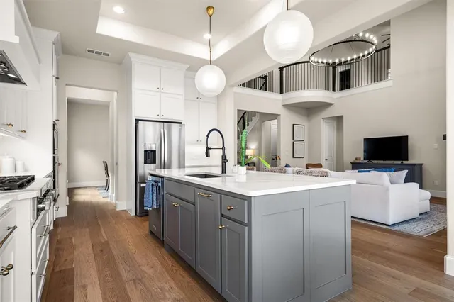 a kitchen with a table chairs refrigerator and microwave