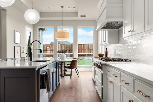 a kitchen with cabinets a sink and a stove