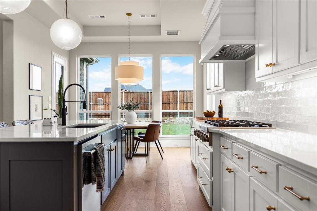 2560 Shady Trail Prosper, TX 75078 - Photo 13 of 40 a kitchen with a sink and cabinets