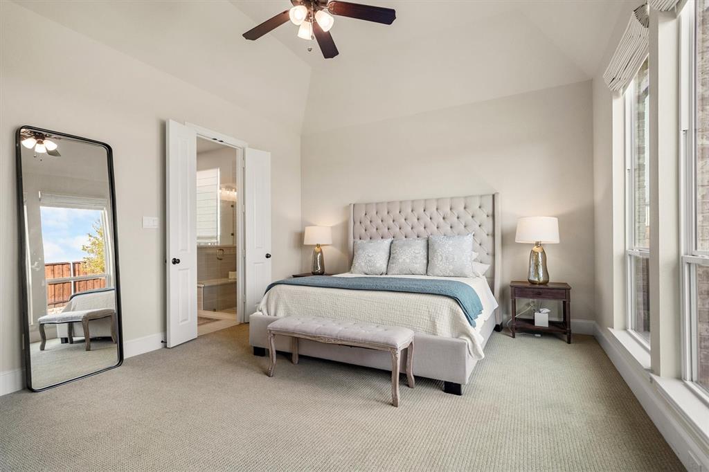 2560 Shady Trail Prosper, TX 75078 - Photo 16 of 40 a bedroom with a bed and a chandelier