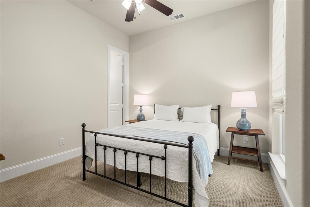 2560 Shady Trail Prosper, TX 75078 - Photo 22 of 40 a bedroom with a bed and a chandelier