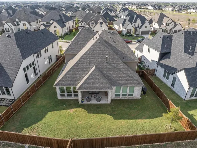 an aerial view of a house with a swimming pool