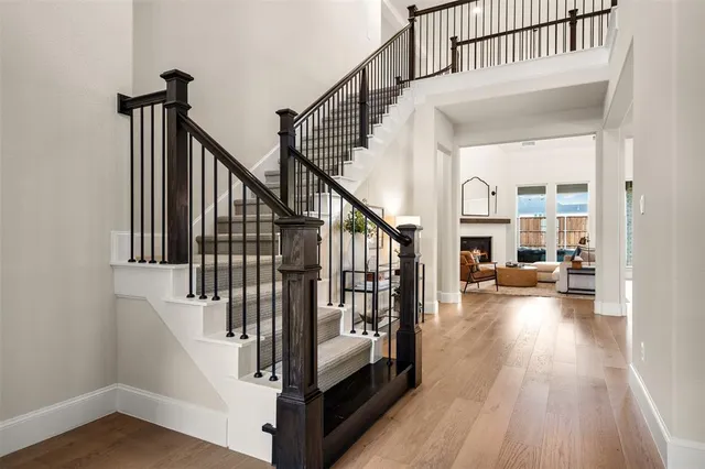 a living room with furniture a fireplace and a floor to ceiling window
