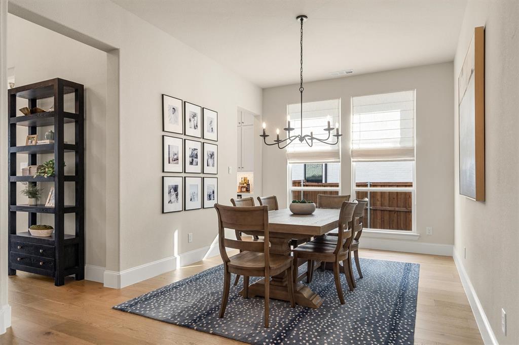 2560 Shady Trail Prosper, TX 75078 - Photo 7 of 40 a view of a dining room with furniture window and wooden floor