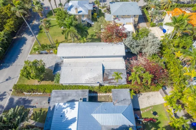 an aerial view of residential houses with outdoor space
