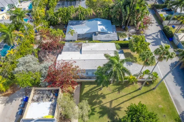 an aerial view of a house with a yard and garden