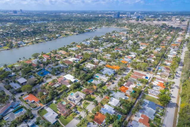 an aerial view of residential houses with outdoor space and swimming pool