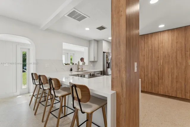 a kitchen with white cabinets and white appliances