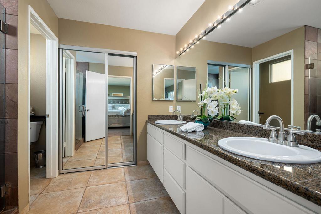 55406 Laurel La La Quinta, CA 92253 - Photo 14 of 50 a bathroom with a granite countertop sink and a mirror