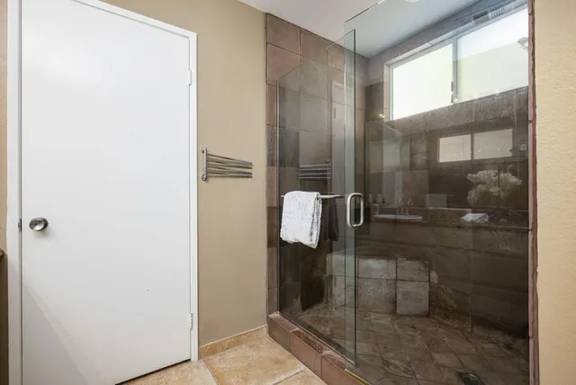 a bathroom with a glass shower door