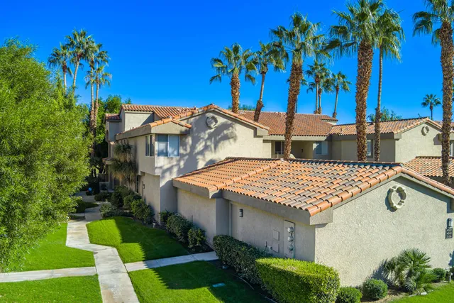 a view of a house with pool and a yard