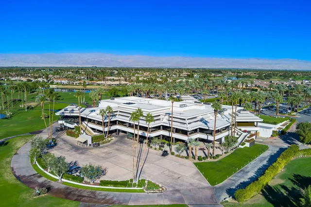 a view of a lake with lawn chairs