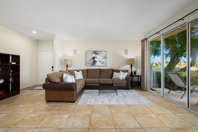a living room with furniture and large windows