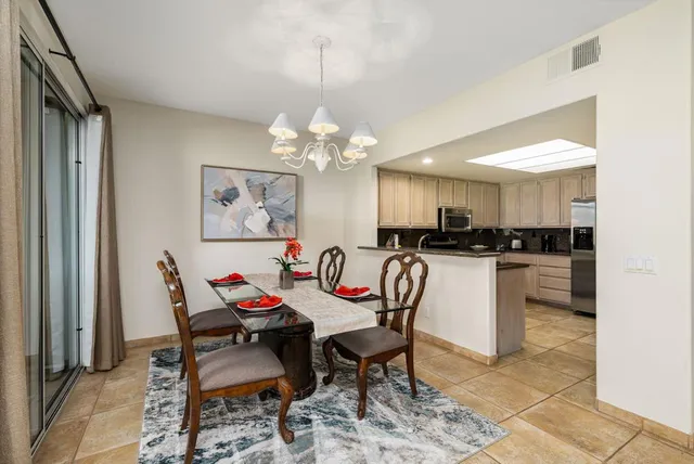 a view of a dining room with furniture and a chandelier
