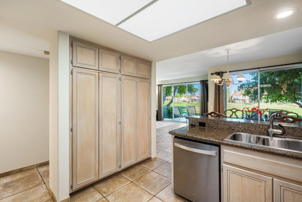 55406 Laurel La La Quinta, CA 92253 - Photo 10 of 50 a kitchen with stainless steel appliances granite countertop a sink stove and cabinets