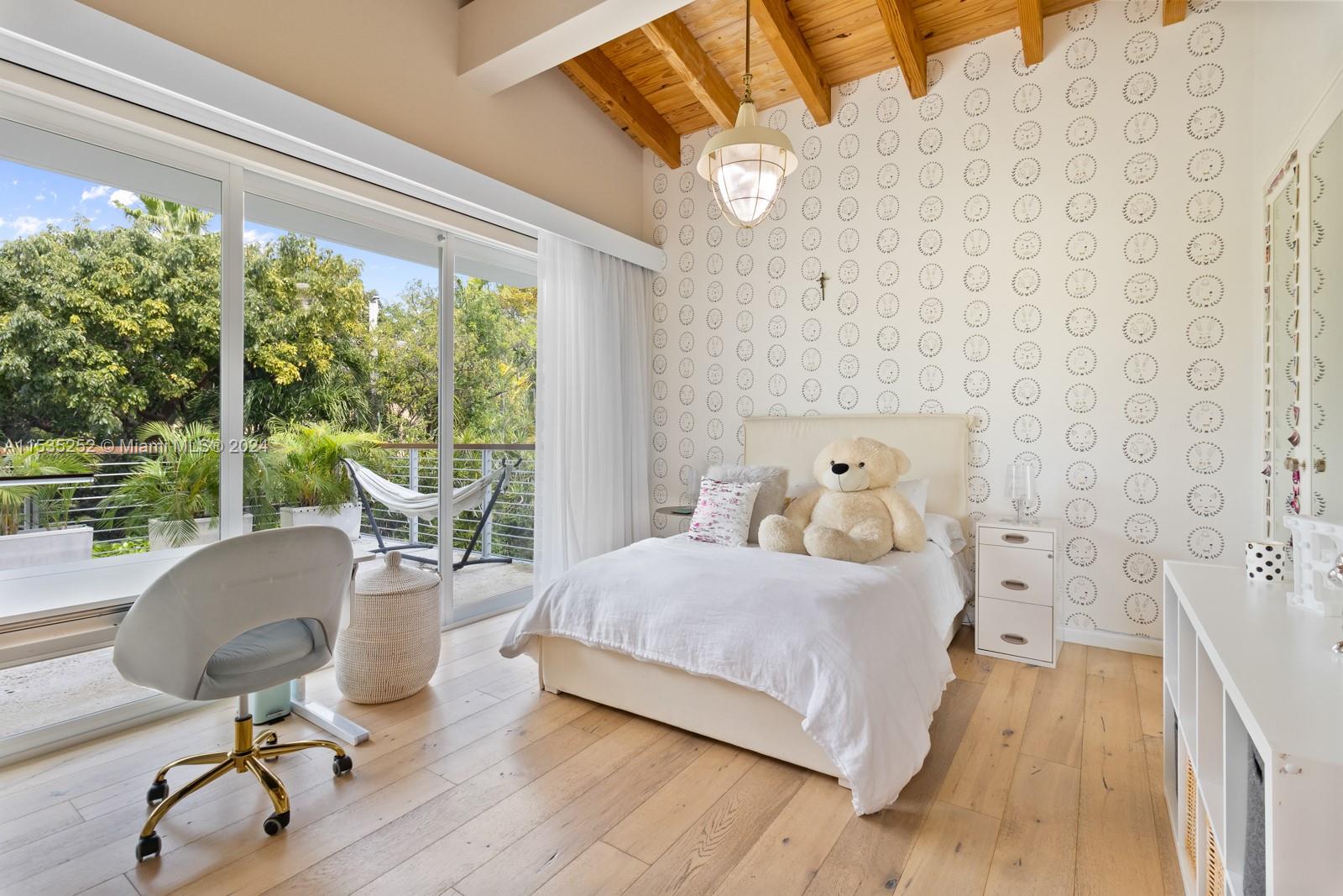 381 Beechwood Drive Key Biscayne, FL 33149 - Photo 21 of 23 a bedroom with a bed and wooden floor