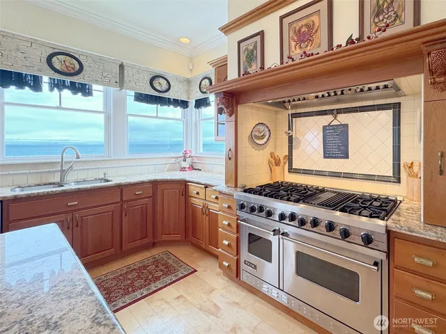 a view of a dining room and livingroom with furniture window and wooden floor