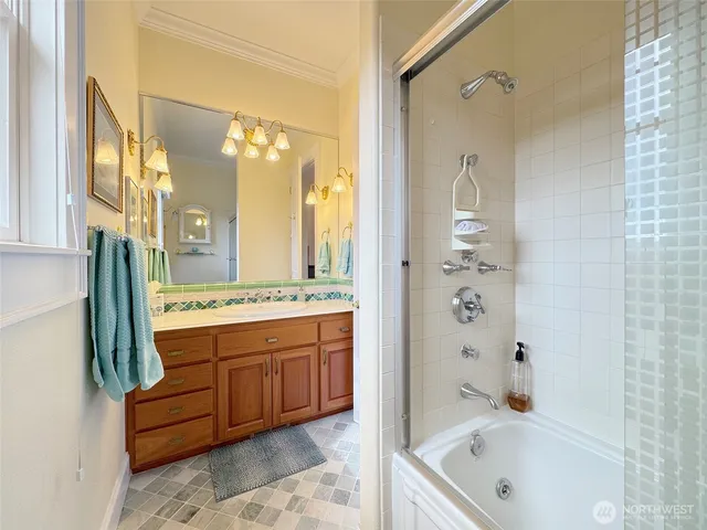 a spacious bedroom with a large bed and a chandelier