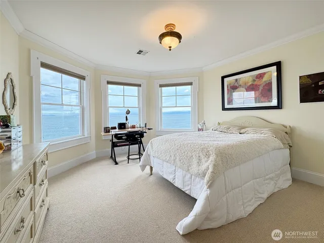 a bedroom with bed and a chandelier