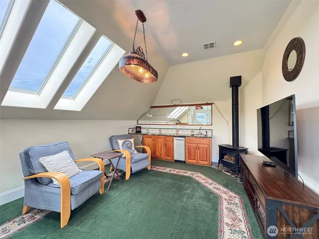 a living room with furniture a rug and white walls