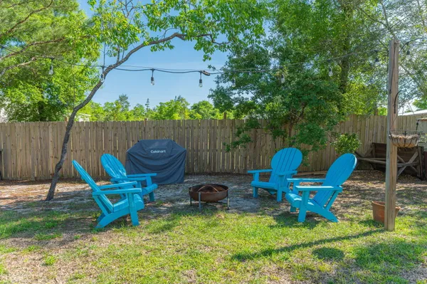 a backyard of a house with table and chairs