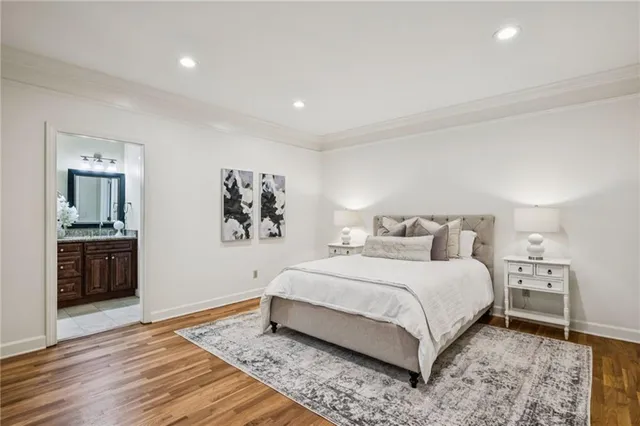 a bedroom with a large bed and painting on the wall