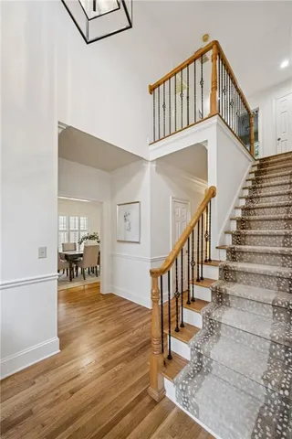 a view of a hallway with wooden floor and entryway