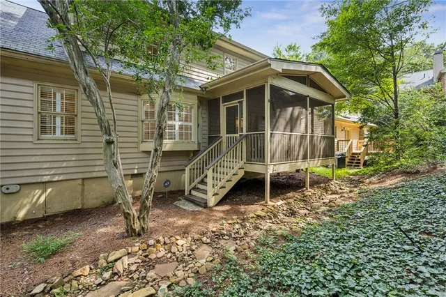 a view of a house with backyard and trees