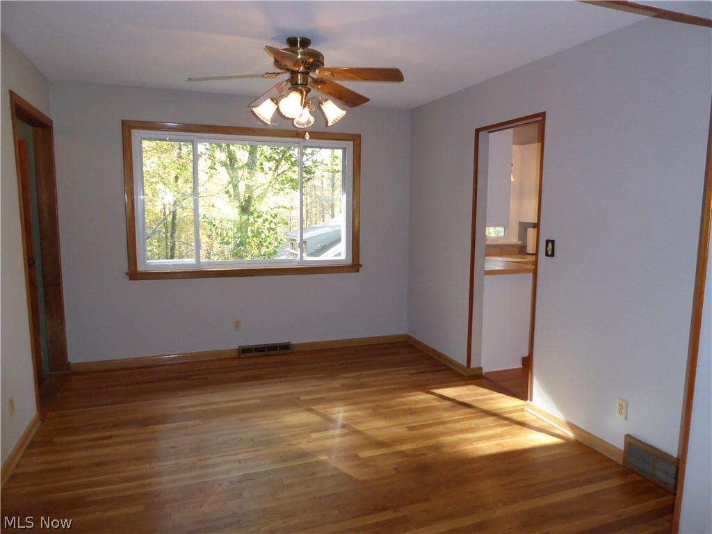 9979 Wilson Mills Road Chardon, OH 44024 - Photo 8 of 35 Formal Dining Overlooking the Private Back Wooded Yard, Refinished Hardwood Flooring and Ceiling Fan and Freshly Painted As Well!