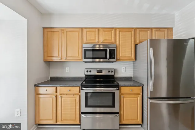 a kitchen with a refrigerator stove and microwave