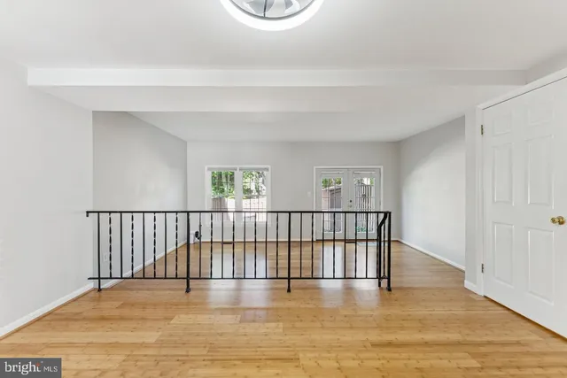 a view of a room with wooden floor and window