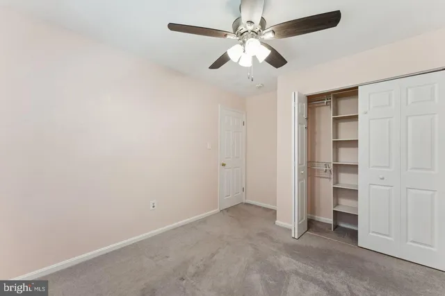 an empty room with a ceiling fan