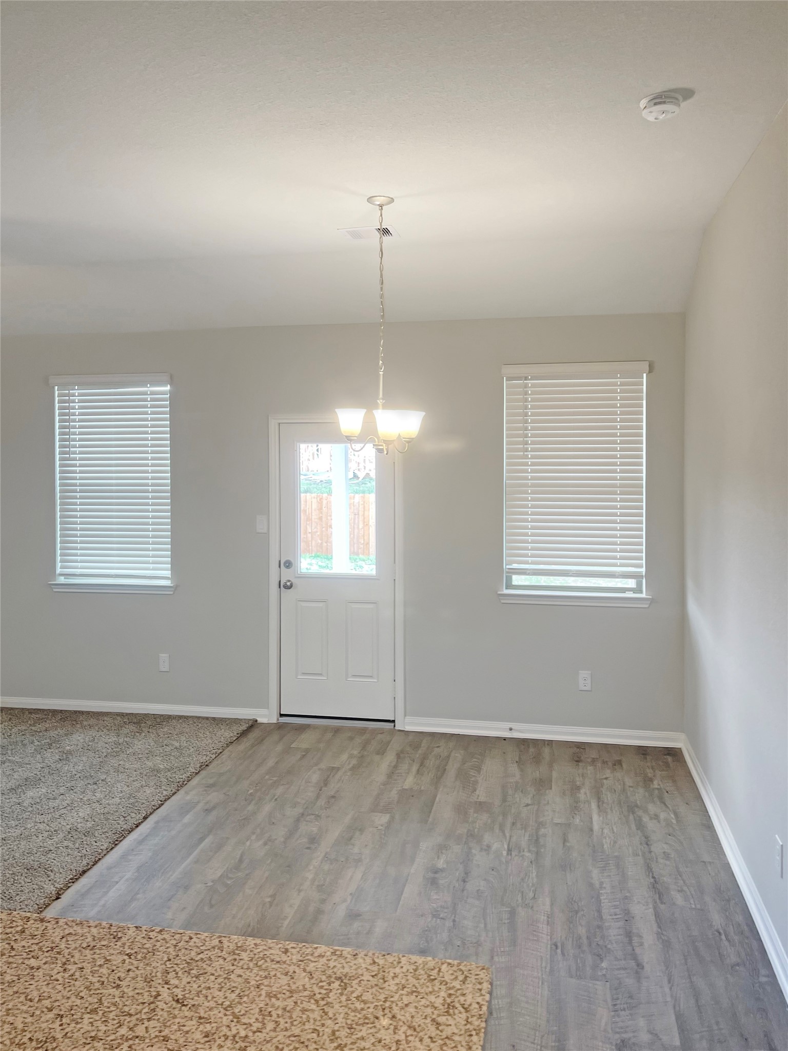 25421 Honus Wagner Way Splendora, TX 77372 - Photo 11 of 24 an empty room with chandelier fan and windows