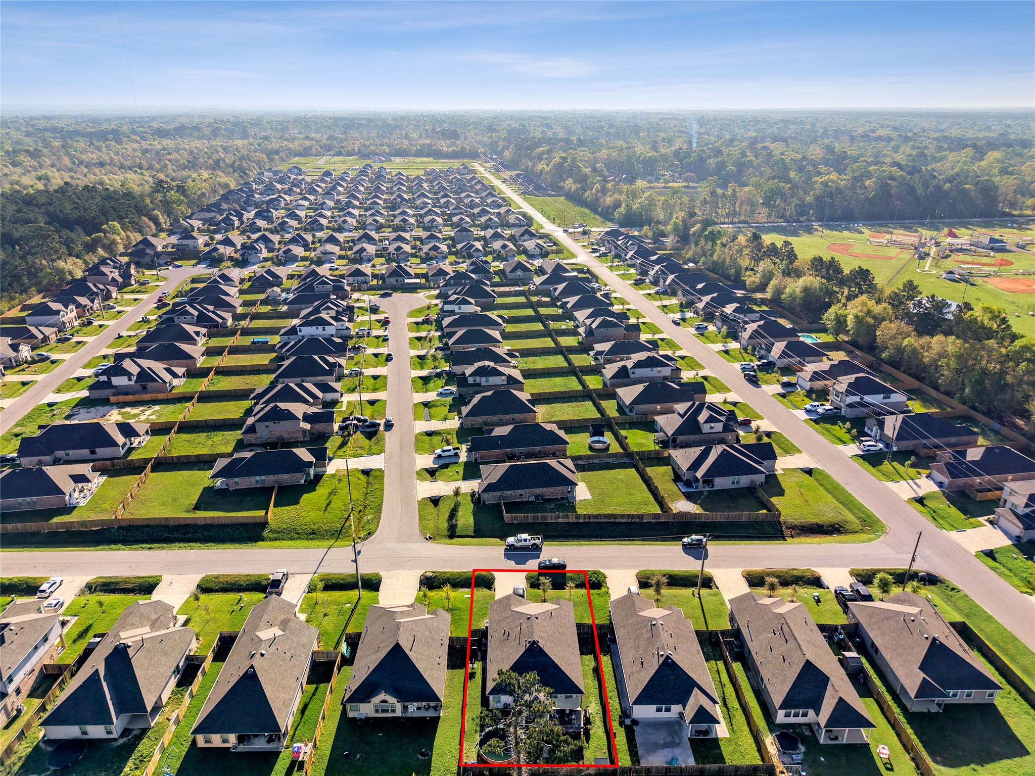 25421 Honus Wagner Way Splendora, TX 77372 - Photo 23 of 24 an aerial view of multiple houses with yard