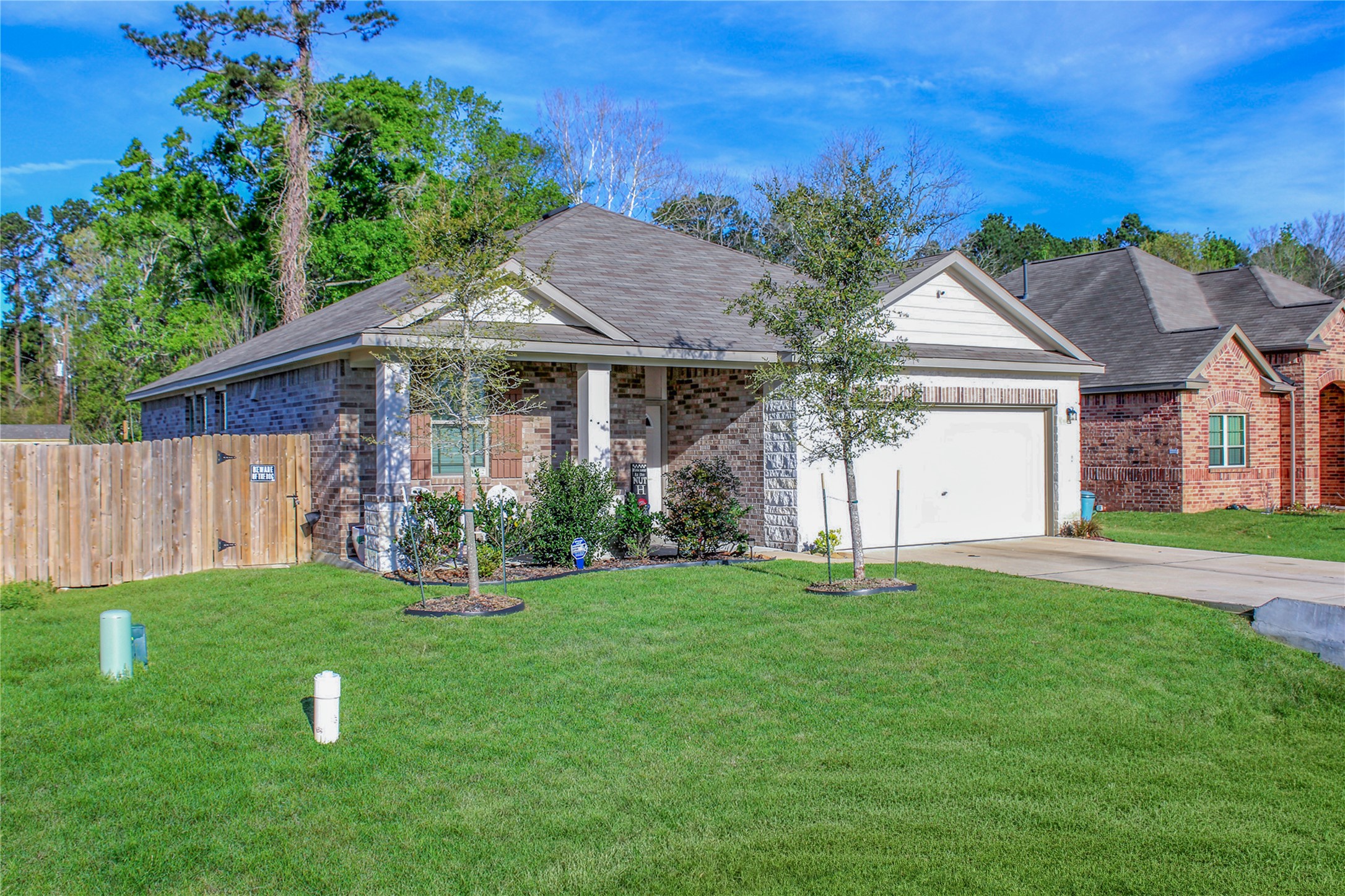 25421 Honus Wagner Way Splendora, TX 77372 - Photo 3 of 24 a front view of a house with a yard