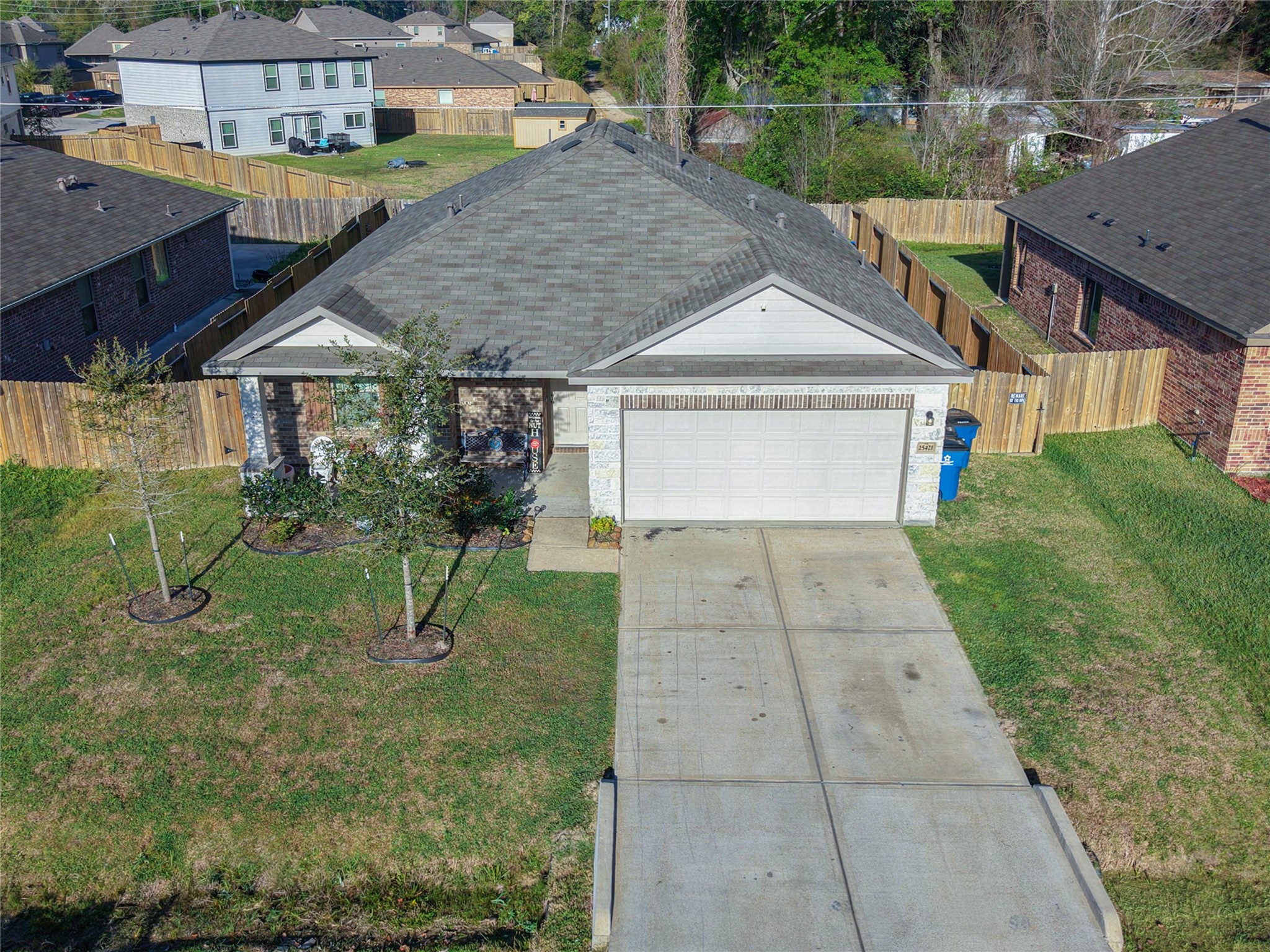 25421 Honus Wagner Way Splendora, TX 77372 - Photo 4 of 24 a house view with a garden space