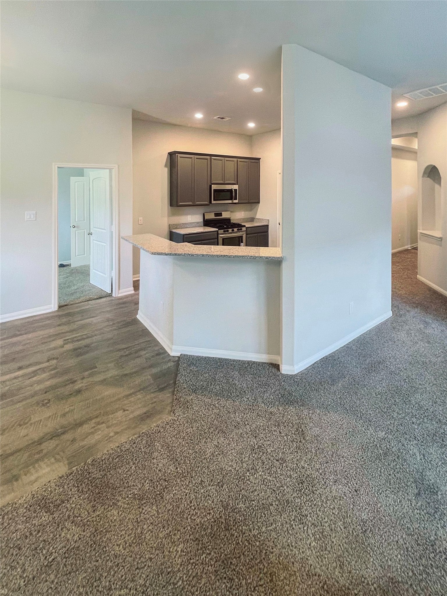 25421 Honus Wagner Way Splendora, TX 77372 - Photo 5 of 24 a view of open kitchen with kitchen island a sink appliances and cabinets