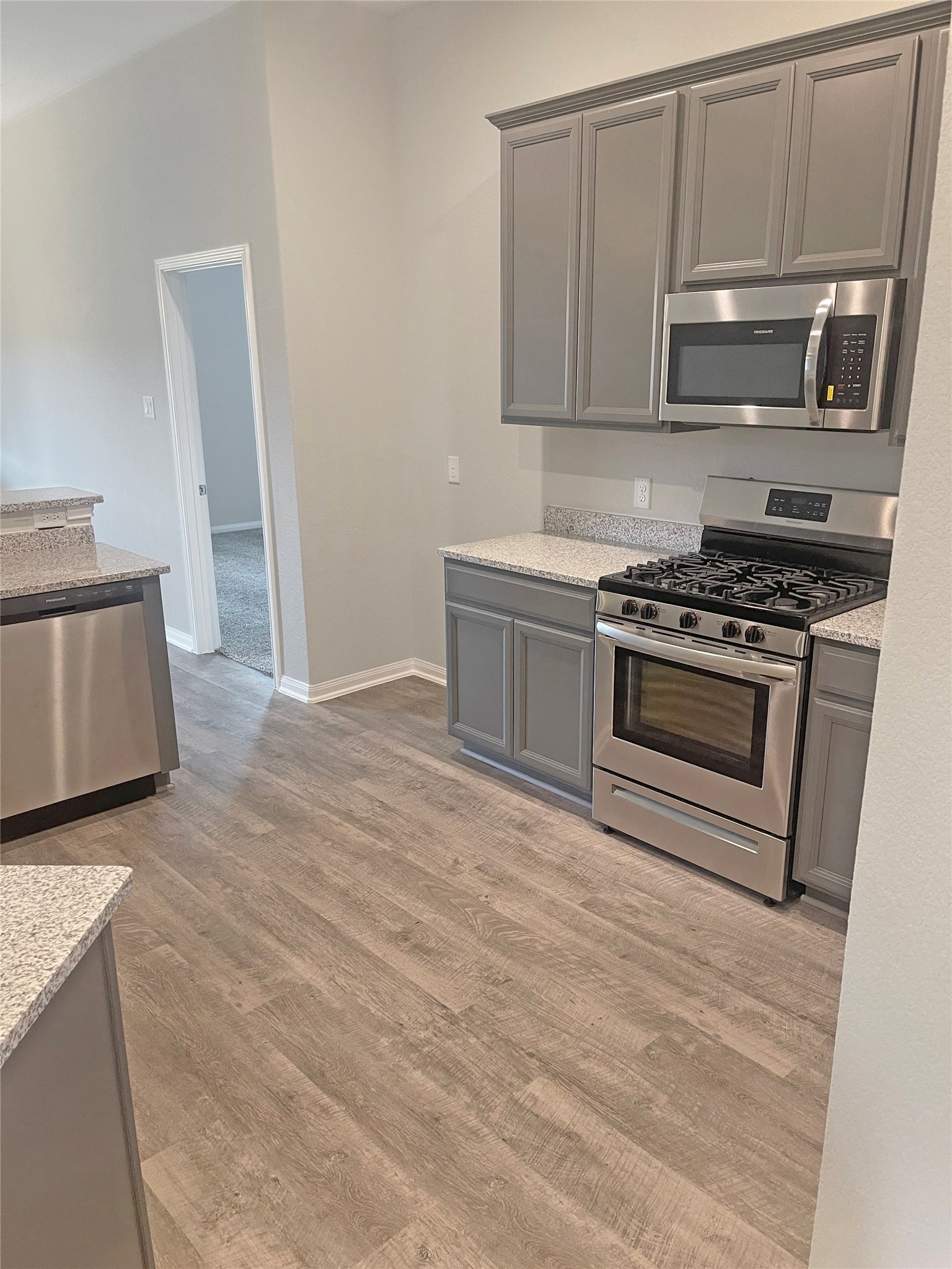 25421 Honus Wagner Way Splendora, TX 77372 - Photo 7 of 24 a kitchen with a stove and a microwave
