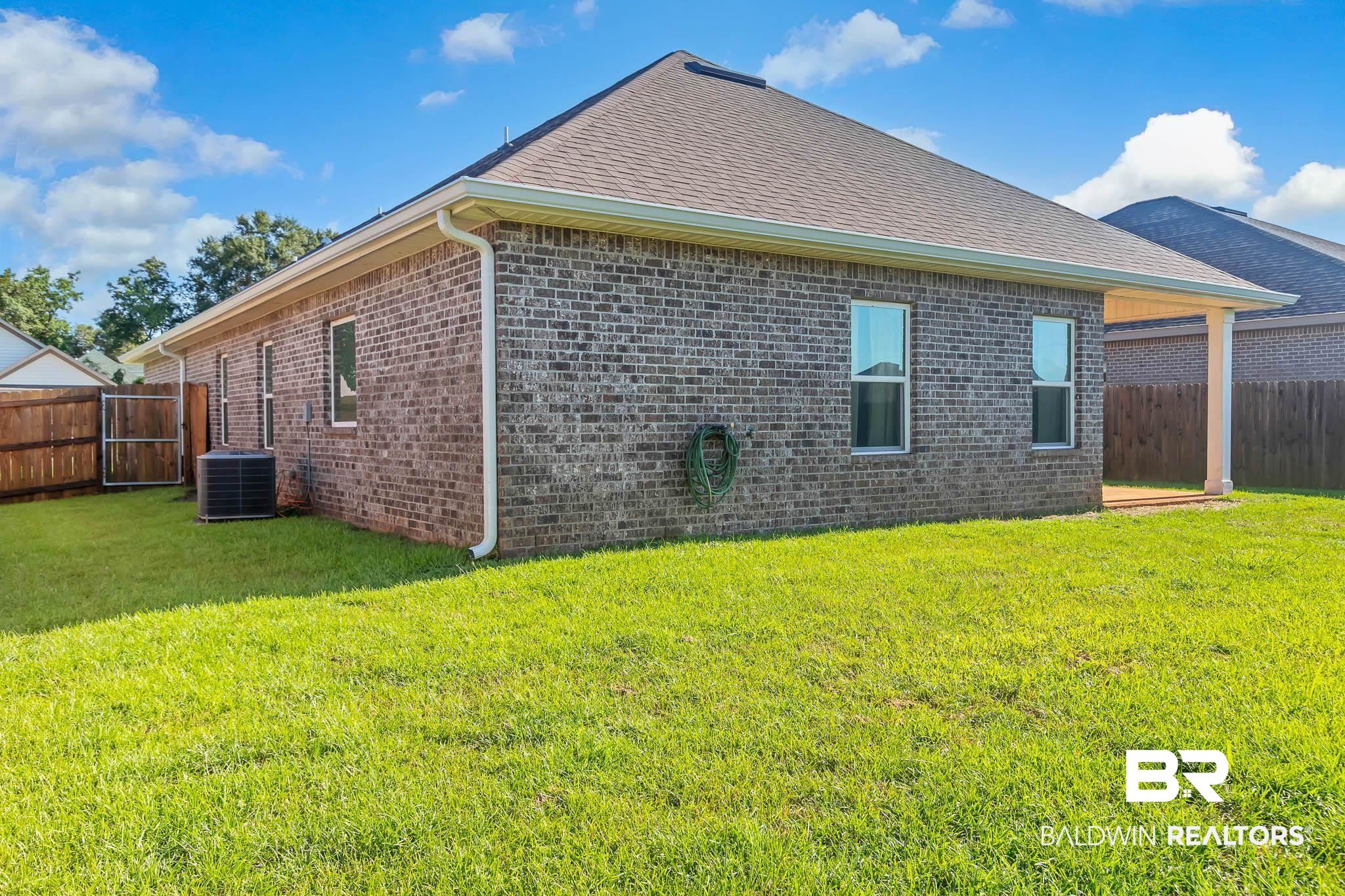 16461 Prado Loop Loxley, AL 36551 - Photo 65 of 78 View of property exterior featuring brick siding and roof with shingles