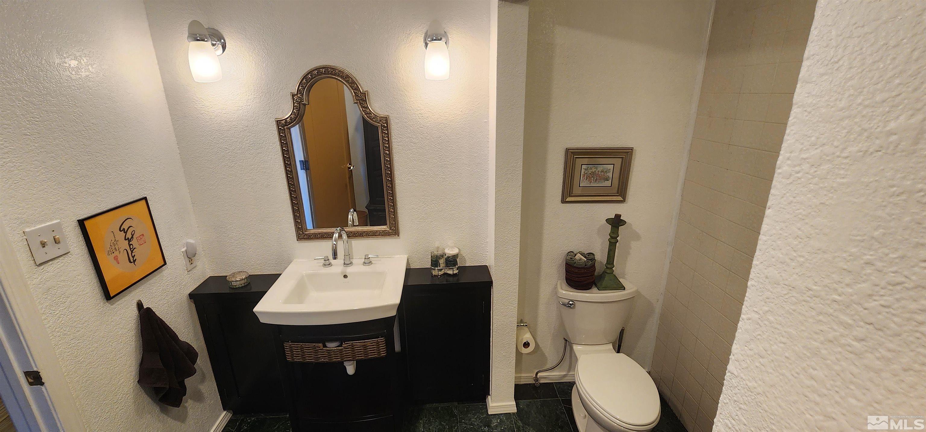 1200 Riverside Drive, Unit 1221 Reno, NV 89503 - Photo 21 of 35 a bathroom with a toilet sink and mirror