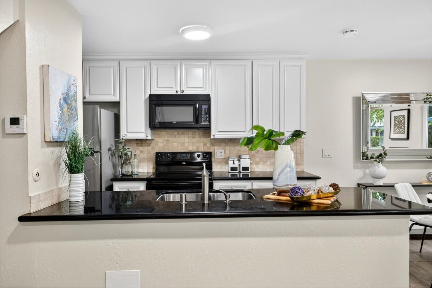 375 North 3rd Street, Unit 3 Campbell, CA 95008 - Photo 4 of 27 a kitchen with stainless steel appliances a sink a microwave a refrigerator and cabinets