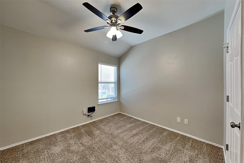 7016 Raintree Way Denton, TX 76210 - Photo 11 of 18 an empty room with windows and fan