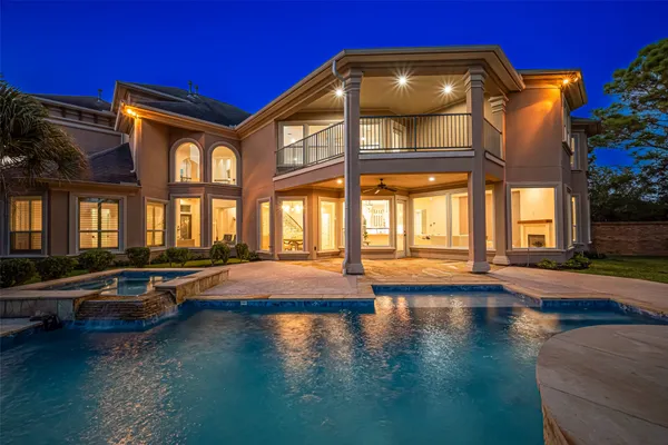 a view of a house with pool and sitting area