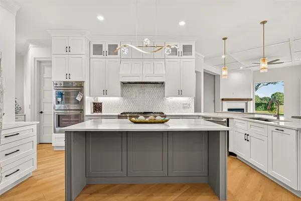 a kitchen with sink stove and cabinets